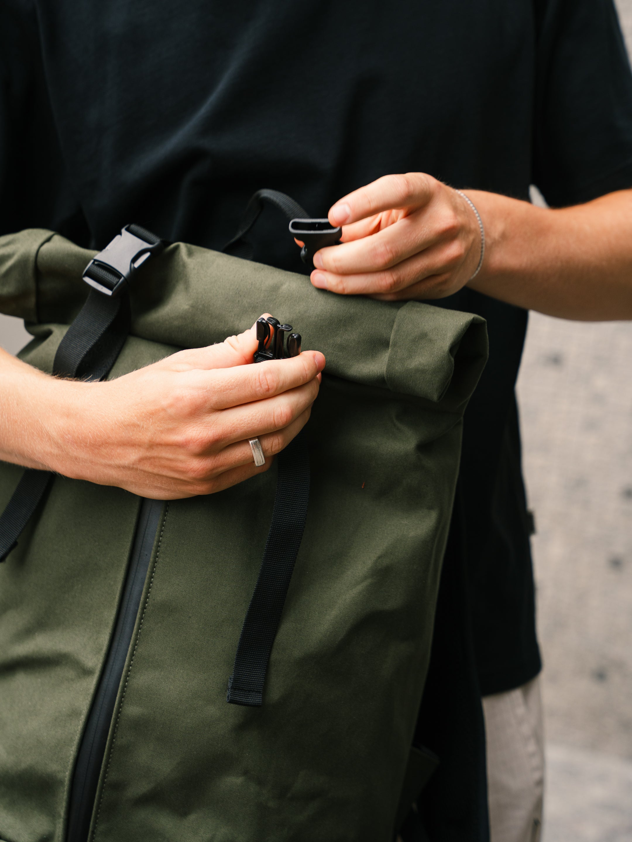Roll-top buckle closure detail on the Bridge Backpack in Khaki Green