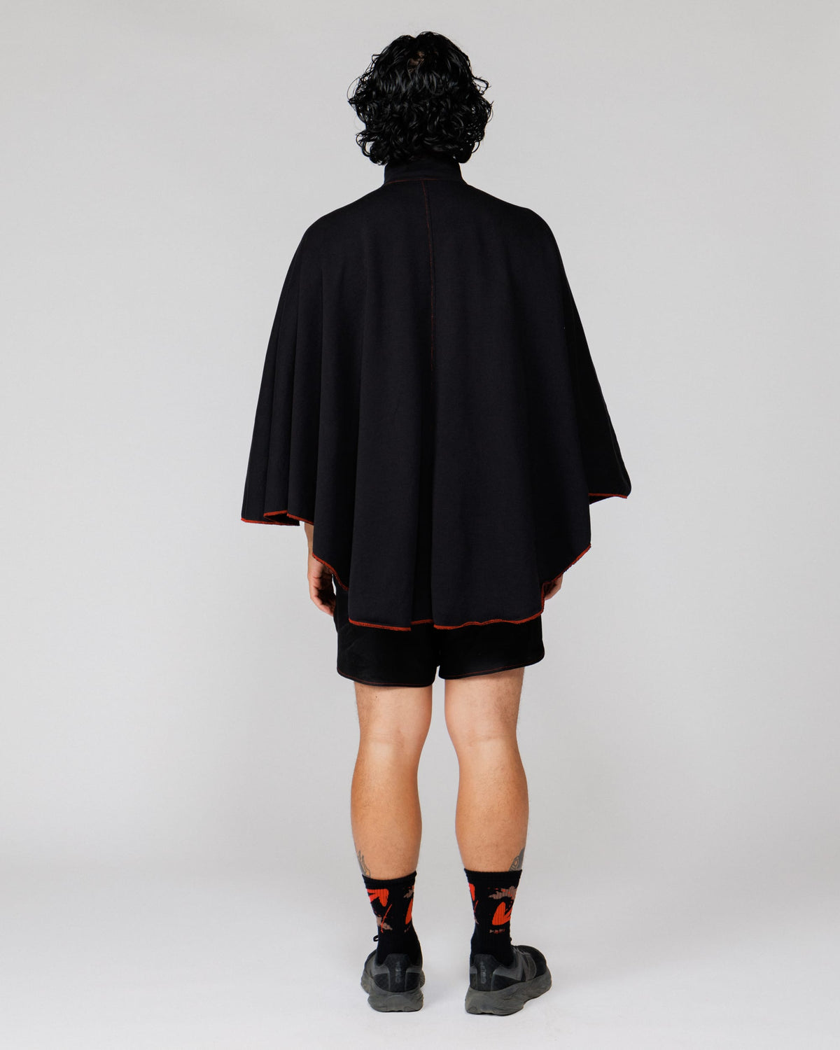 Model wearing the Outnback Recovery Cape in black, full-length back view