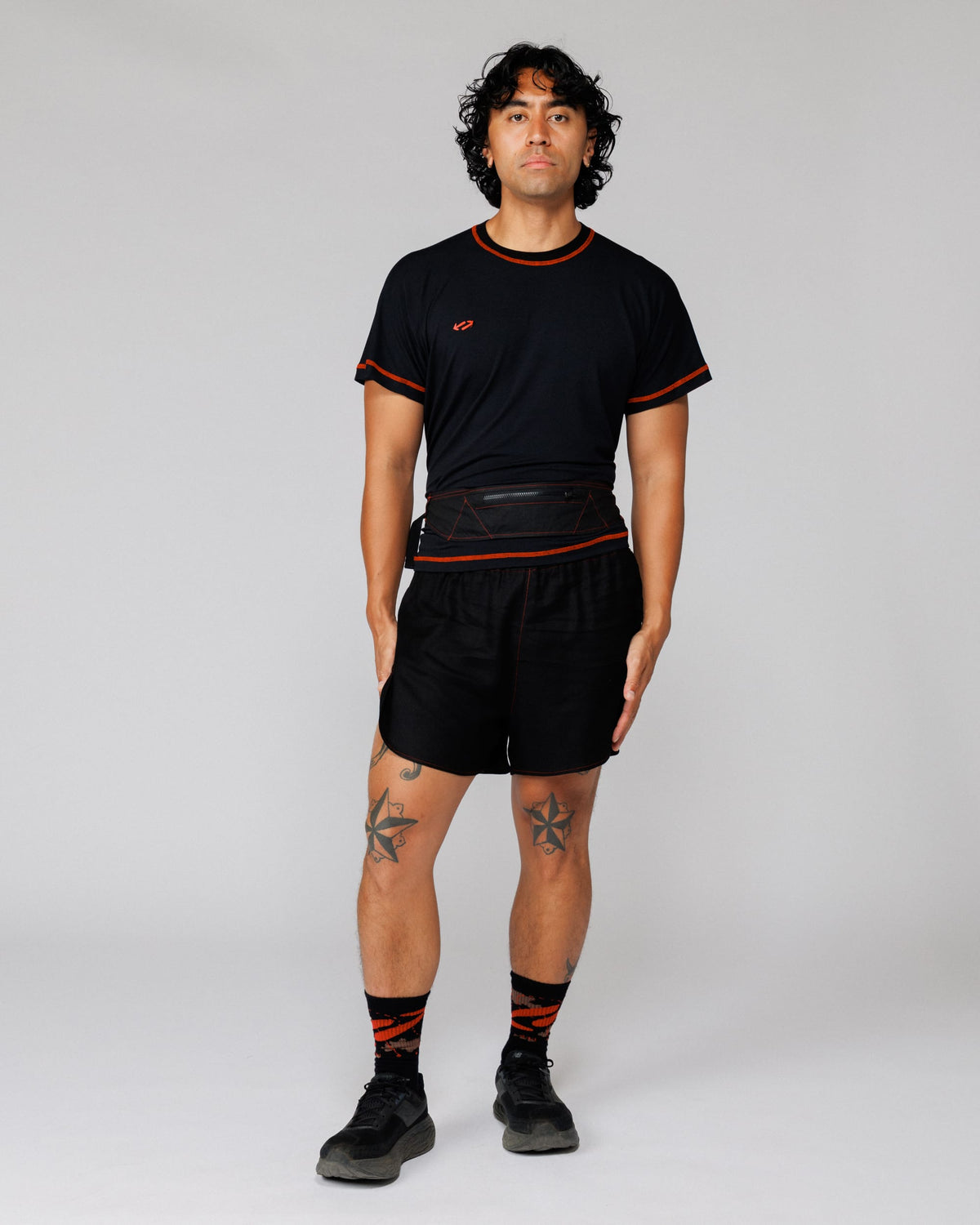 Model wearing the Outnback Running Strap in black at the waist, front view