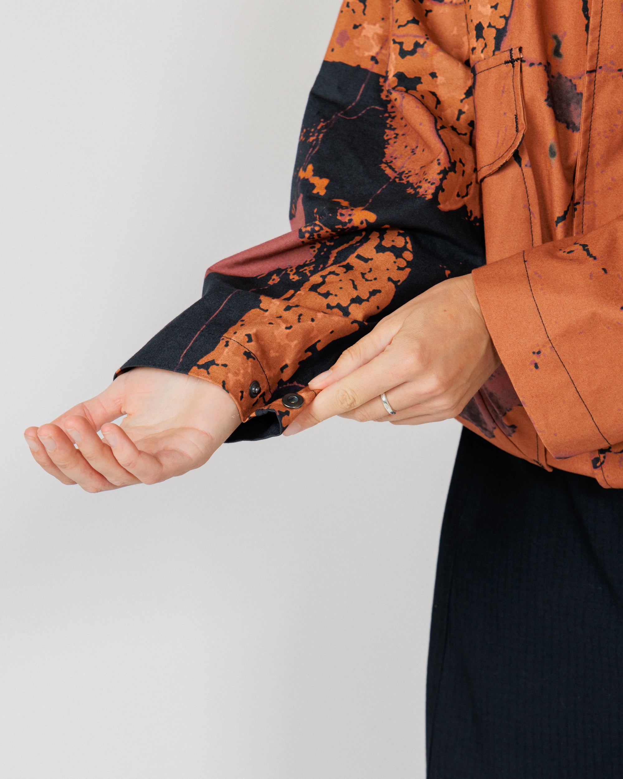 Roam Raglan Jacket - Abstract Brick Camo — cuff snap adjuster on model