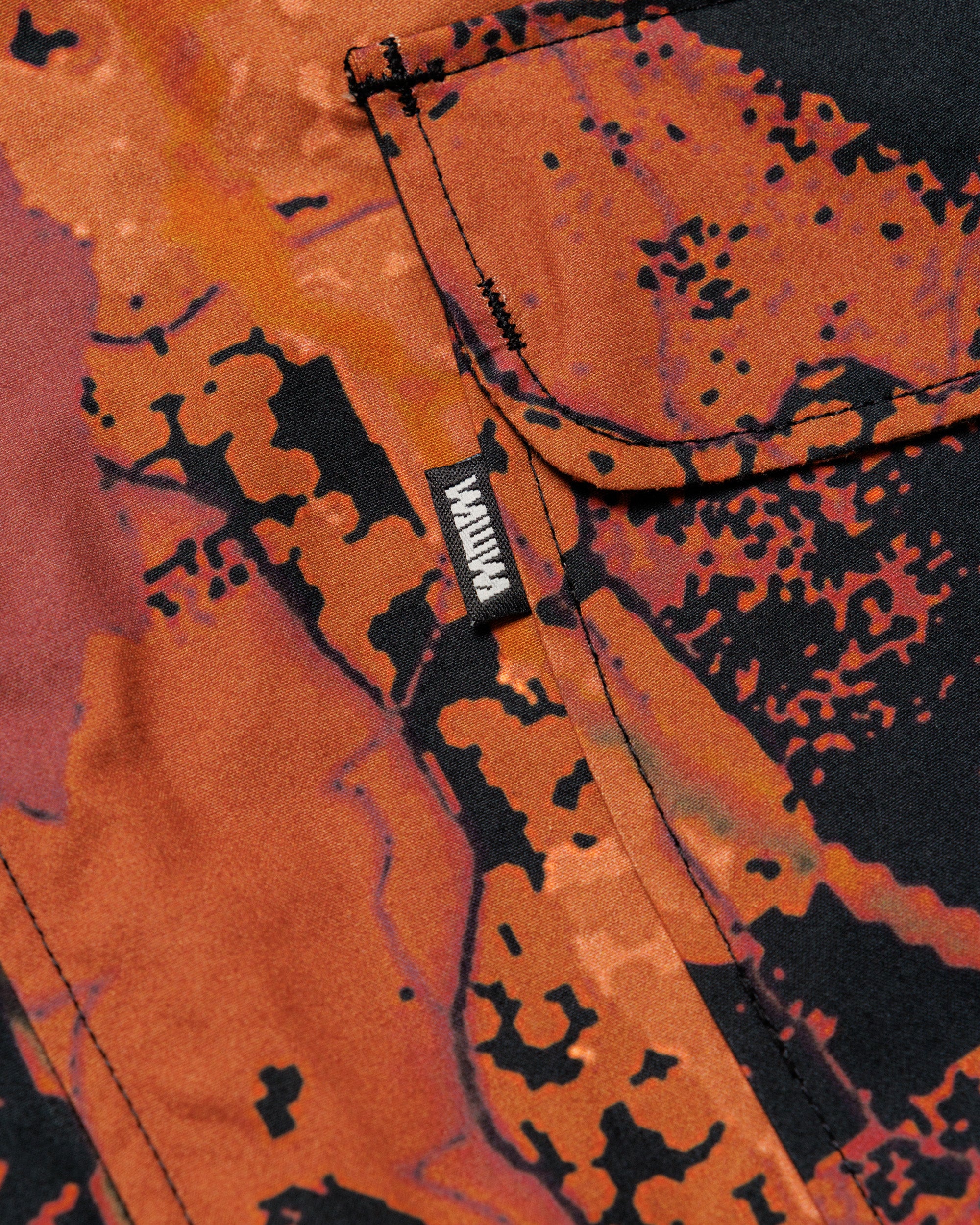 Roam Raglan Jacket - Abstract Brick Camo — pocket flap and brand label
