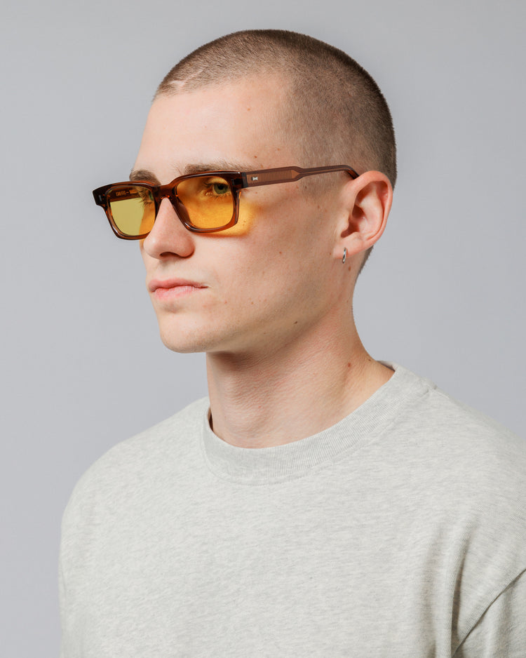 Model wearing Solaris Sunglasses in coconut, three-quarter view