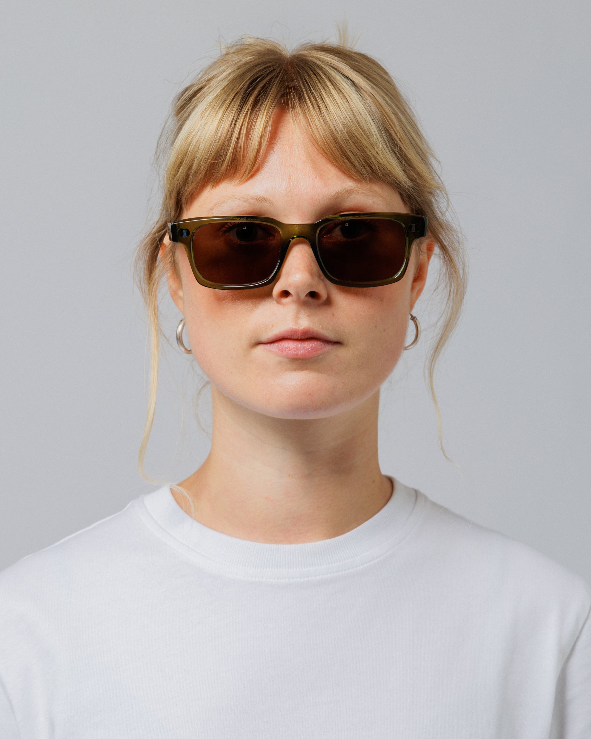Female model wearing Solaris Sunglasses in khaki, front view